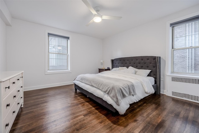 bedroom with ceiling fan, radiator heating unit, and dark wood-type flooring