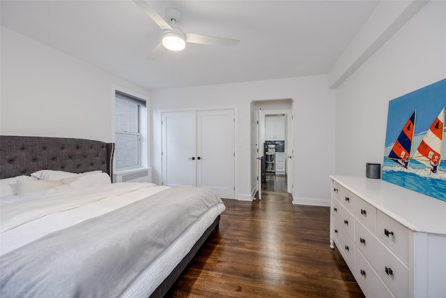 bedroom with a closet, ceiling fan, and dark hardwood / wood-style flooring