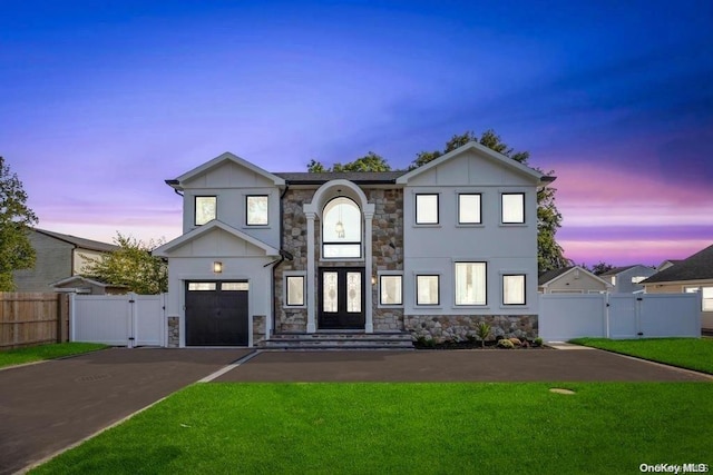 view of front facade with a yard and a garage