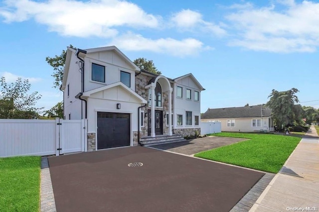 view of front of property featuring a front yard and a garage