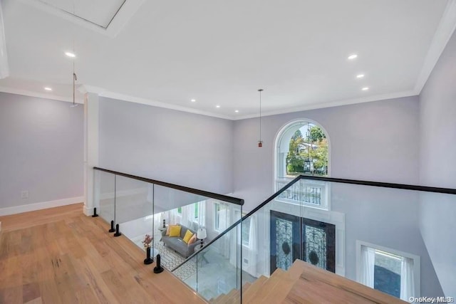 corridor featuring light hardwood / wood-style floors and ornamental molding