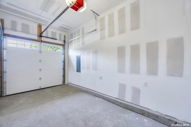 garage with electric panel and a garage door opener