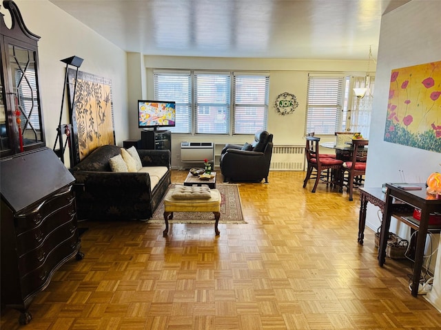 living room with a chandelier, heating unit, light parquet floors, and radiator