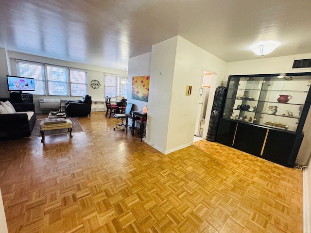 interior space featuring radiator heating unit and light parquet flooring