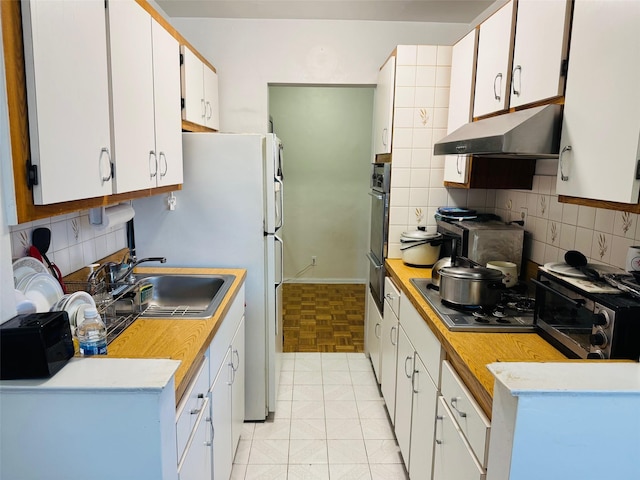 kitchen with backsplash, white cabinetry, sink, and stainless steel gas cooktop