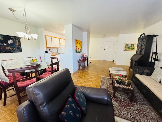 living room with parquet flooring, washer / clothes dryer, and a chandelier