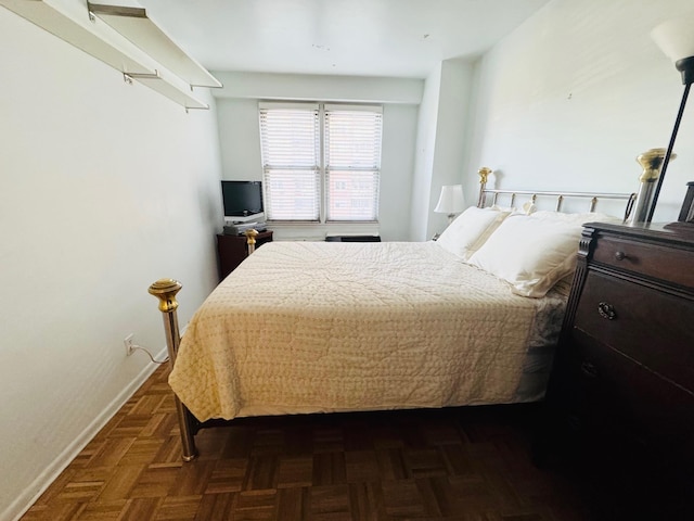 bedroom featuring dark parquet flooring