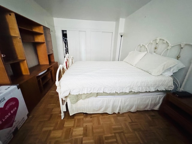 bedroom with dark parquet floors