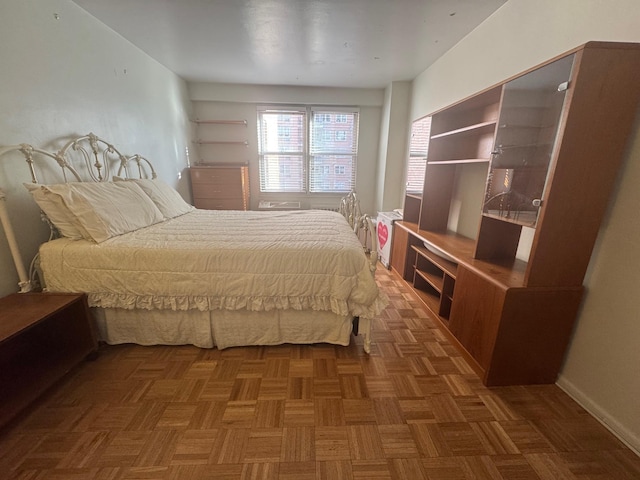 bedroom with dark parquet floors