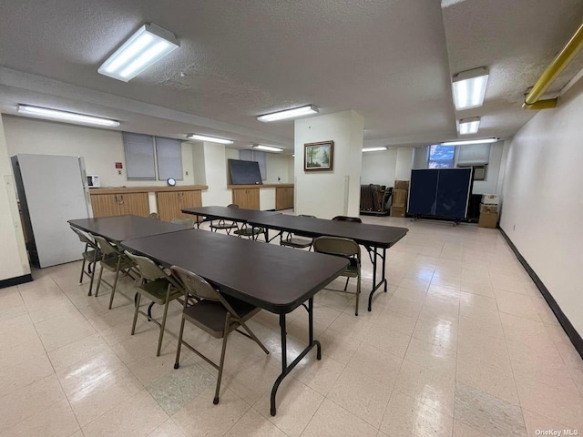 recreation room with a textured ceiling