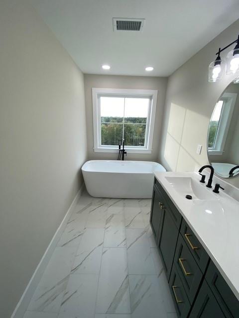 bathroom with vanity and a bathtub