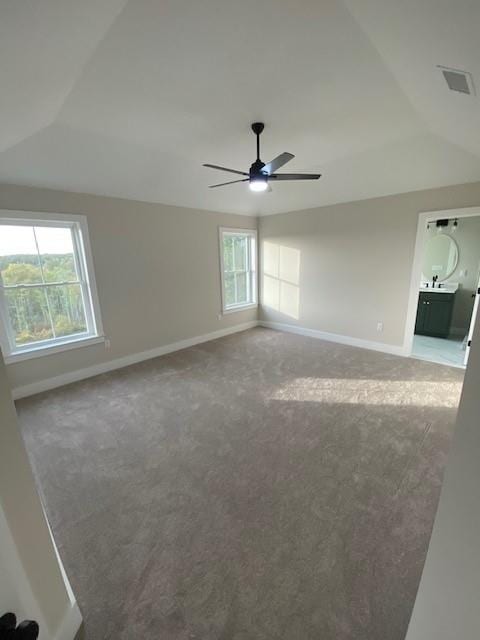 empty room featuring carpet, ceiling fan, and lofted ceiling