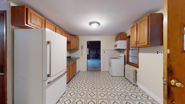 kitchen with radiator and white appliances