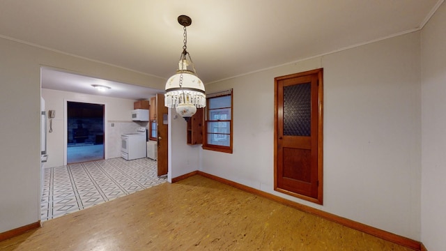 unfurnished dining area with crown molding and a chandelier