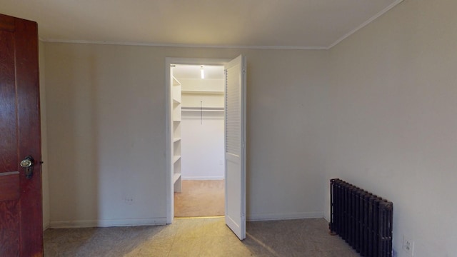 corridor with ornamental molding and radiator