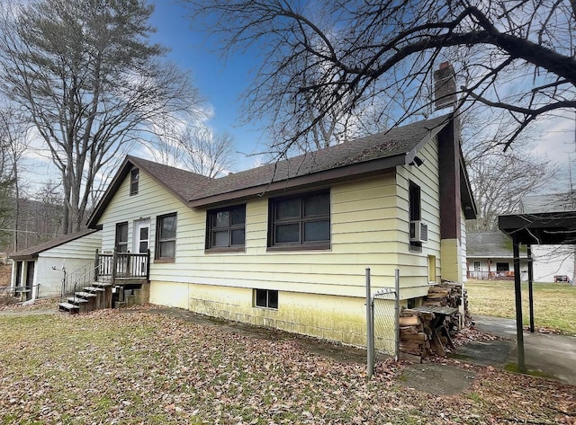 view of side of home featuring cooling unit