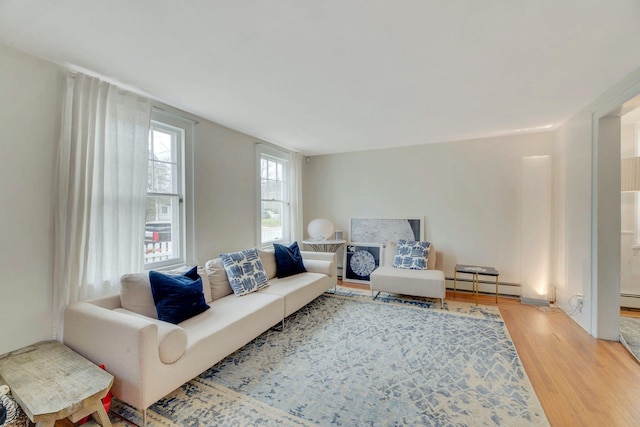 living room featuring baseboard heating, wood finished floors, and a baseboard radiator