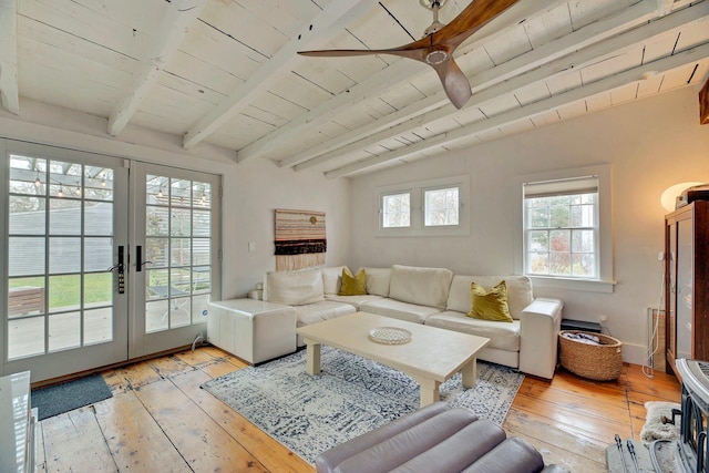 living area with lofted ceiling with beams, light wood-style flooring, wooden ceiling, french doors, and a ceiling fan