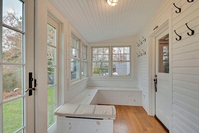 unfurnished sunroom featuring vaulted ceiling and wooden ceiling