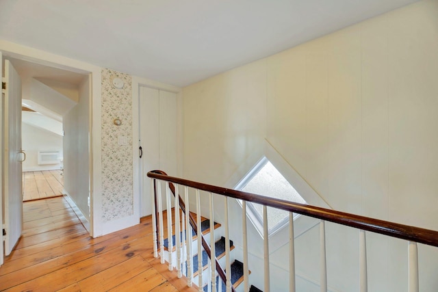 stairway with hardwood / wood-style flooring