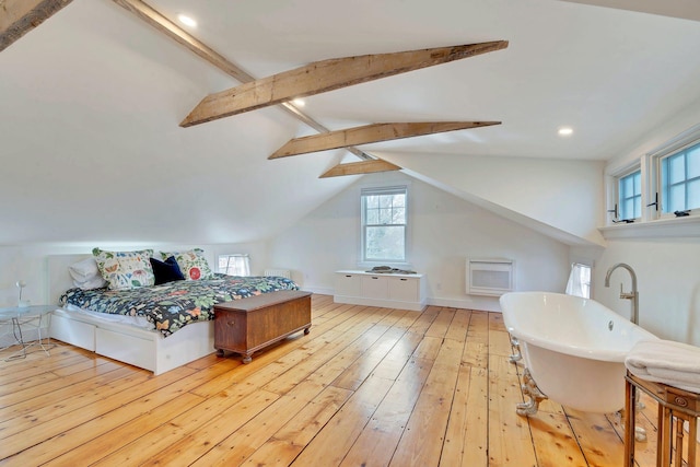 bedroom featuring vaulted ceiling with beams, light wood-type flooring, and baseboards