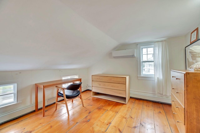 office space featuring a wall mounted air conditioner, a baseboard heating unit, lofted ceiling, and light wood finished floors