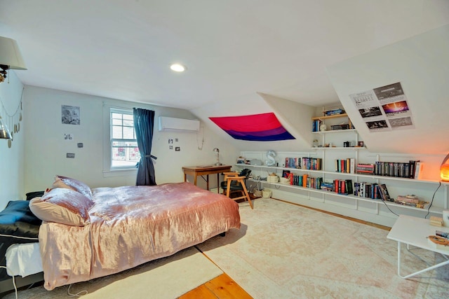 bedroom with lofted ceiling, wood finished floors, and a wall mounted AC