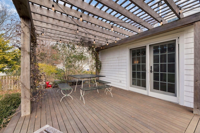 wooden deck featuring outdoor dining area, french doors, and a pergola