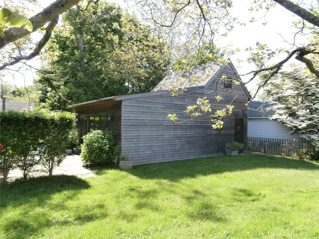 view of side of property featuring a yard and fence