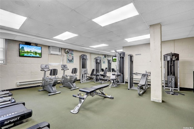 exercise room featuring a drop ceiling, carpet floors, and a wall mounted AC