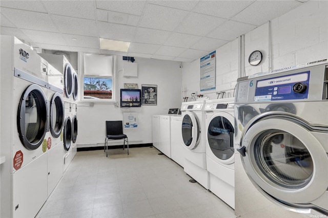 laundry area with stacked washing maching and dryer and washing machine and clothes dryer