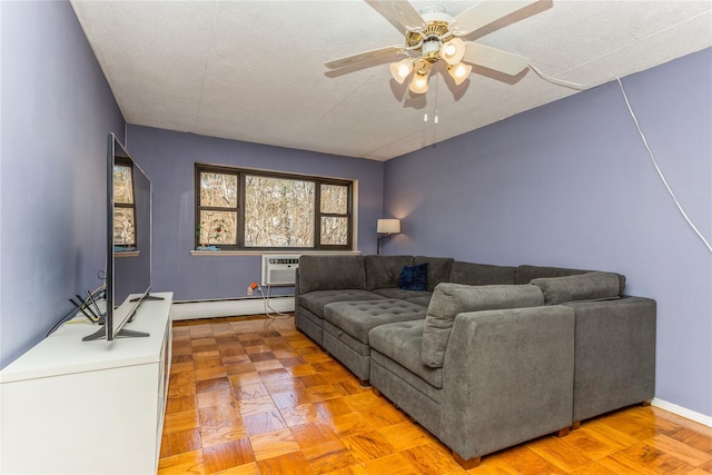 living room with ceiling fan, light parquet floors, a baseboard radiator, and a textured ceiling