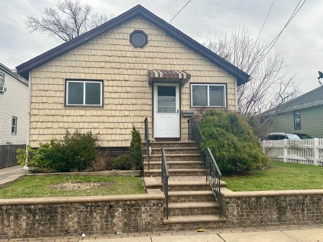 bungalow with a front yard