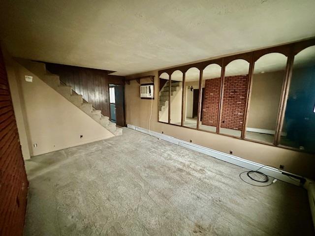 interior space featuring carpet flooring and an AC wall unit