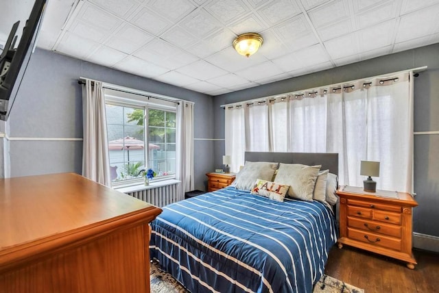 bedroom with dark wood-type flooring