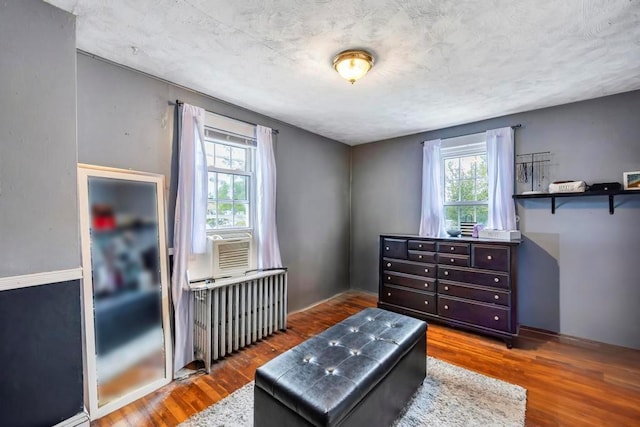 living area featuring dark wood-type flooring and radiator