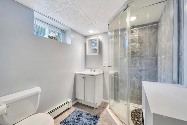 bathroom featuring a paneled ceiling, tile patterned floors, toilet, baseboard heating, and a shower with shower door