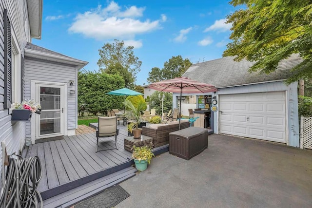 wooden terrace featuring an outdoor living space and a garage