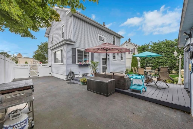 rear view of house featuring an outdoor hangout area and a wooden deck