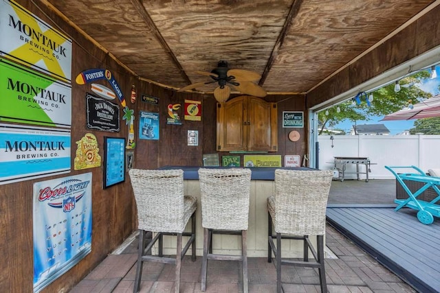 exterior space featuring ceiling fan, a deck, and an outdoor bar