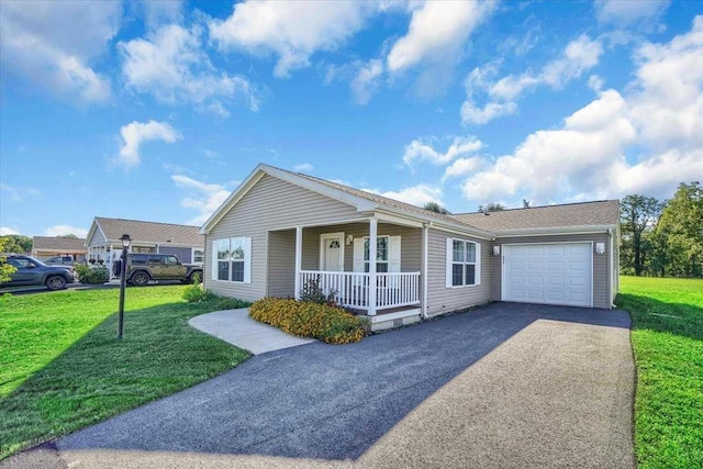 ranch-style house featuring a porch, a garage, and a front yard