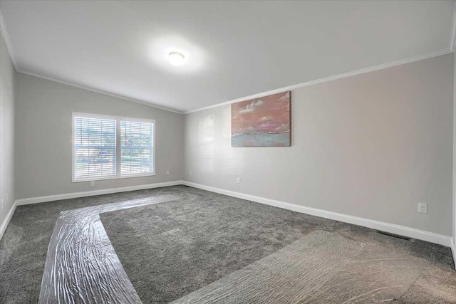 spare room featuring dark carpet, lofted ceiling, and crown molding