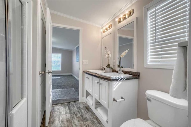 bathroom featuring vanity, lofted ceiling, crown molding, toilet, and wood-type flooring