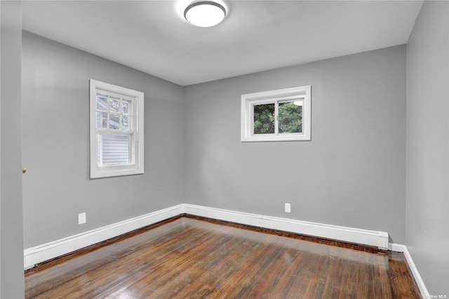 spare room with hardwood / wood-style flooring and a baseboard radiator