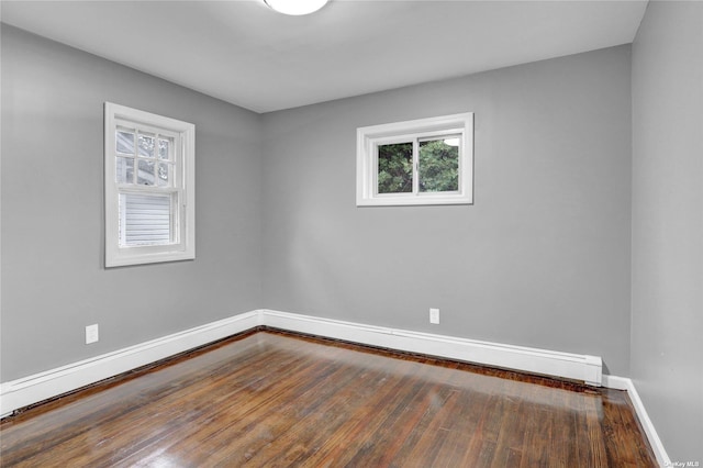 unfurnished room with wood-type flooring