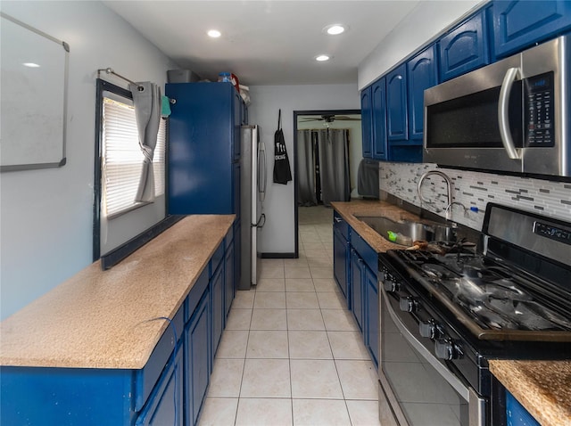 kitchen featuring blue cabinetry and appliances with stainless steel finishes