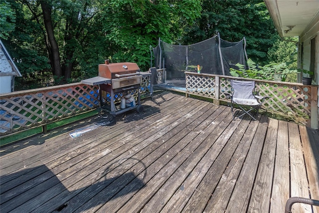 wooden deck with a trampoline