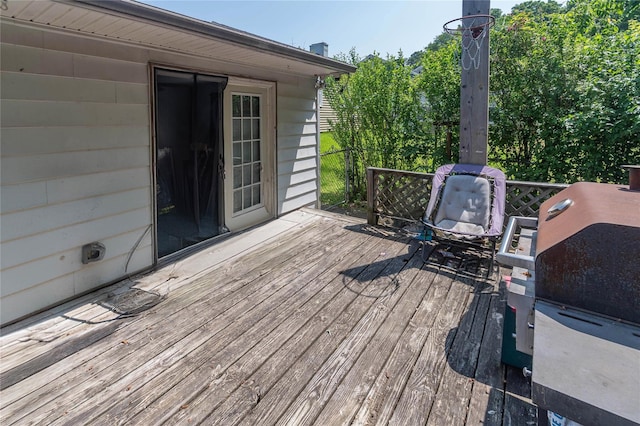 wooden deck with a grill