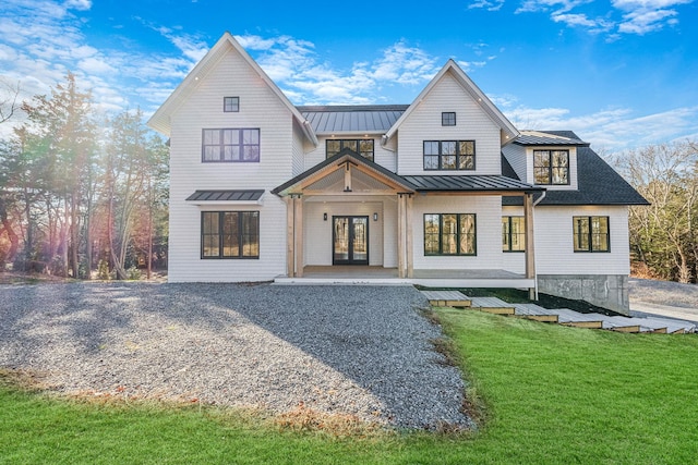 back of property featuring a yard and french doors