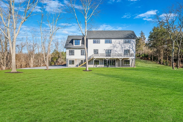 back of house with a lawn